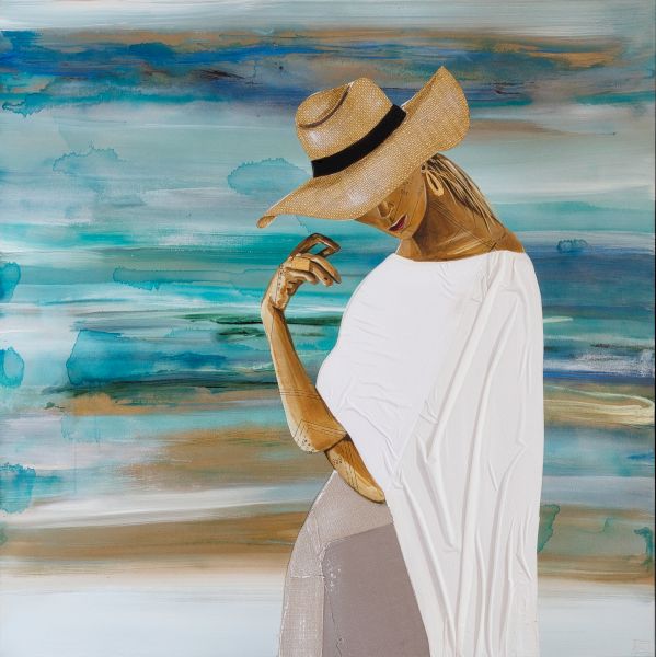 A person wearing a wide-brim straw hat and white cape-like top stands in front of an abstract blue-green background, posing thoughtfully.